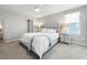Main bedroom with plush carpet, large window, and upholstered headboard at 9605 Channing Hill Dr, Sun City Center, FL 33573