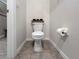 Toilet room with white toilet, neutral walls and tile flooring at 9605 Channing Hill Dr, Sun City Center, FL 33573