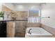 Bathroom featuring bathtub, shower and a window bringing in lots of natural light at 10516 Gretna Green Dr, Tampa, FL 33626