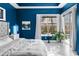 Bright bedroom with blue walls, white trim, and sliding doors leading to the pool at 10516 Gretna Green Dr, Tampa, FL 33626