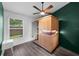 A bedroom with a modern sauna, neutral floors, a ceiling fan, and ample natural light from the large window at 10516 Gretna Green Dr, Tampa, FL 33626