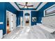 Spacious bedroom featuring blue walls, white trim, and doorways to other rooms at 10516 Gretna Green Dr, Tampa, FL 33626