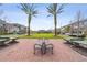 Inviting park featuring mature palm trees, benches, ping pong tables and a green space, perfect for relaxing and enjoying community amenities at 10516 Gretna Green Dr, Tampa, FL 33626