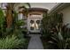 Charming entryway with double doors and lush landscaping at 10516 Gretna Green Dr, Tampa, FL 33626