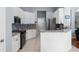 Well-lit kitchen with white cabinets, granite countertops, black appliances, and tile flooring at 10516 Gretna Green Dr, Tampa, FL 33626