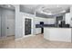 Open kitchen area featuring an island, white cabinets, and modern appliances at 10516 Gretna Green Dr, Tampa, FL 33626