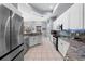 A bright kitchen with white cabinets, granite countertops, and stainless steel appliances at 10516 Gretna Green Dr, Tampa, FL 33626