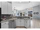 Open-concept kitchen with a breakfast bar and granite countertops adjoins the living area at 10516 Gretna Green Dr, Tampa, FL 33626