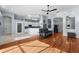 Open-concept living room featuring hardwood floors, tile flooring, and easy access to kitchen at 10516 Gretna Green Dr, Tampa, FL 33626