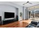 Living room featuring hardwood floors, a large television, recessed lighting, and a view of the lanai at 10516 Gretna Green Dr, Tampa, FL 33626