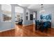 Open-concept living room with hardwood floors, grey walls, modern lighting, and views of the dining and living areas at 10516 Gretna Green Dr, Tampa, FL 33626