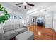 Bright open-concept living space with a gray sofa and wood flooring at 10516 Gretna Green Dr, Tampa, FL 33626