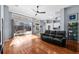 Bright living room featuring hardwood floors, a ceiling fan, and sliding glass doors leading to a screened lanai at 10516 Gretna Green Dr, Tampa, FL 33626
