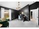 Bright home office features a dark accent wall, tile flooring, and views of backyard through window at 10516 Gretna Green Dr, Tampa, FL 33626