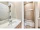 Bright bathroom featuring a vanity with sink and a shower/tub combination with sliding glass door at 10645 Ruffino Ct, Trinity, FL 34655