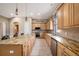 Open kitchen featuring granite countertops, light wood cabinets, and stainless steel appliances offering ample counter space at 10645 Ruffino Ct, Trinity, FL 34655
