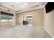 Large living room featuring neutral carpet and wet bar at 10645 Ruffino Ct, Trinity, FL 34655