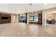 Spacious living room with tile floors, a media center, and a view of dining room and the outdoor pool at 10645 Ruffino Ct, Trinity, FL 34655