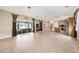 Open concept living space featuring access to the outdoor patio and a kitchen with a large kitchen island at 10645 Ruffino Ct, Trinity, FL 34655