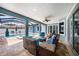 Covered patio with ample seating and a view of the sparkling pool and spa at 10645 Ruffino Ct, Trinity, FL 34655