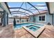 Refreshing pool and spa with screened-in enclosure offering privacy and sun protection at 10645 Ruffino Ct, Trinity, FL 34655