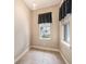 Bonus room featuring neutral walls, tile floor, and two windows providing natural light at 10645 Ruffino Ct, Trinity, FL 34655