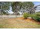 Spacious backyard with lush lawn, mature trees, and partial view of the lake at 10709 Rockledge View Dr, Riverview, FL 33579