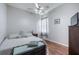 Bedroom with neutral walls, hardwood floors, ceiling fan, and a large chest at the foot of bed at 10709 Rockledge View Dr, Riverview, FL 33579