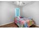 Cheerful bedroom with a colorful butterfly-themed comforter and a ceiling fan at 10709 Rockledge View Dr, Riverview, FL 33579