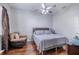 Neutral bedroom featuring hardwood floors, ceiling fan, and a leather chair at 10709 Rockledge View Dr, Riverview, FL 33579