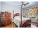 Traditional bedroom with a four poster bed, hardwood floors, dresser, and natural light at 10709 Rockledge View Dr, Riverview, FL 33579
