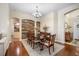Formal dining room with wood accent wall, elegant chandelier, and seating for six at 10709 Rockledge View Dr, Riverview, FL 33579