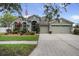 Charming home with a three-car garage, manicured landscaping, and a welcoming entrance at 10709 Rockledge View Dr, Riverview, FL 33579