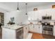 Modern kitchen with white cabinets, stainless steel appliances, and granite countertops at 10709 Rockledge View Dr, Riverview, FL 33579