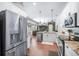 Bright kitchen with stainless appliances, white cabinets, granite counters and open floor plan at 10709 Rockledge View Dr, Riverview, FL 33579