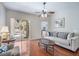 Cozy living room featuring hardwood floors, comfortable seating, and view of enclosed lanai at 10709 Rockledge View Dr, Riverview, FL 33579