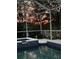 Evening view of this gorgeous pool and jacuzzi featuring beautiful blue tile accents and outdoor lighting at 10709 Rockledge View Dr, Riverview, FL 33579