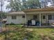 View of the back of the house featuring a covered patio and a large yard at 10932 N 21St St, Tampa, FL 33612