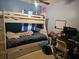Bedroom featuring bunk beds, a desk area, and natural light at 10932 N 21St St, Tampa, FL 33612
