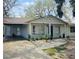 Cozy single-story home with an attached carport and a welcoming front porch at 10932 N 21St St, Tampa, FL 33612