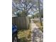 Street view of the sidewalk next to a wooden fence and mature trees at 10932 N 21St St, Tampa, FL 33612