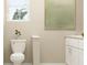 Modern bathroom featuring a toilet, stylish accents, and a neutral color palette at 11083 E 65Th Ter, Palmetto, FL 34221
