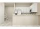 Contemporary kitchen with white cabinetry, stainless steel appliances, and ample counter space at 11083 E 65Th Ter, Palmetto, FL 34221