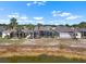 Aerial view of home showcasing exterior living space, landscaping, and adjacent body of water at 1110 Jasmine Creek Ct, Sun City Center, FL 33573
