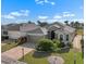 Aerial view showcasing a well-maintained home, lush landscaping, and a brick-paved driveway at 1110 Jasmine Creek Ct, Sun City Center, FL 33573