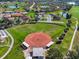 Aerial view of a baseball field and sports amenities surrounded by trees and residences at 1110 Jasmine Creek Ct, Sun City Center, FL 33573