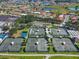 Overhead shot of tennis courts surrounded by houses, trees, and water features, offering a recreational lifestyle at 1110 Jasmine Creek Ct, Sun City Center, FL 33573