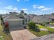 Aerial view showcasing a well-maintained home, lush landscaping, and a brick-paved driveway at 1110 Jasmine Creek Ct, Sun City Center, FL 33573