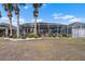 Lush backyard with screened-in patio, surrounded by mature trees at 1110 Jasmine Creek Ct, Sun City Center, FL 33573
