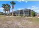 Landscaped backyard featuring a large screened-in lanai, perfect for outdoor enjoyment at 1110 Jasmine Creek Ct, Sun City Center, FL 33573